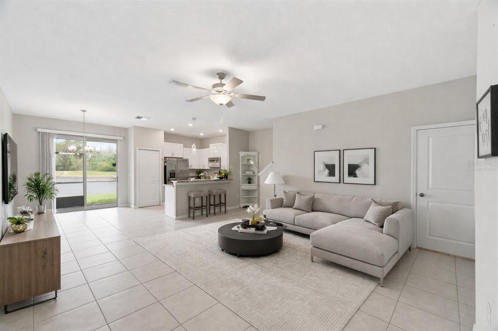 8606 Reedville Street New Port Richey, FL 34654 - Photo 8 of 100 a living room with furniture and a chandelier