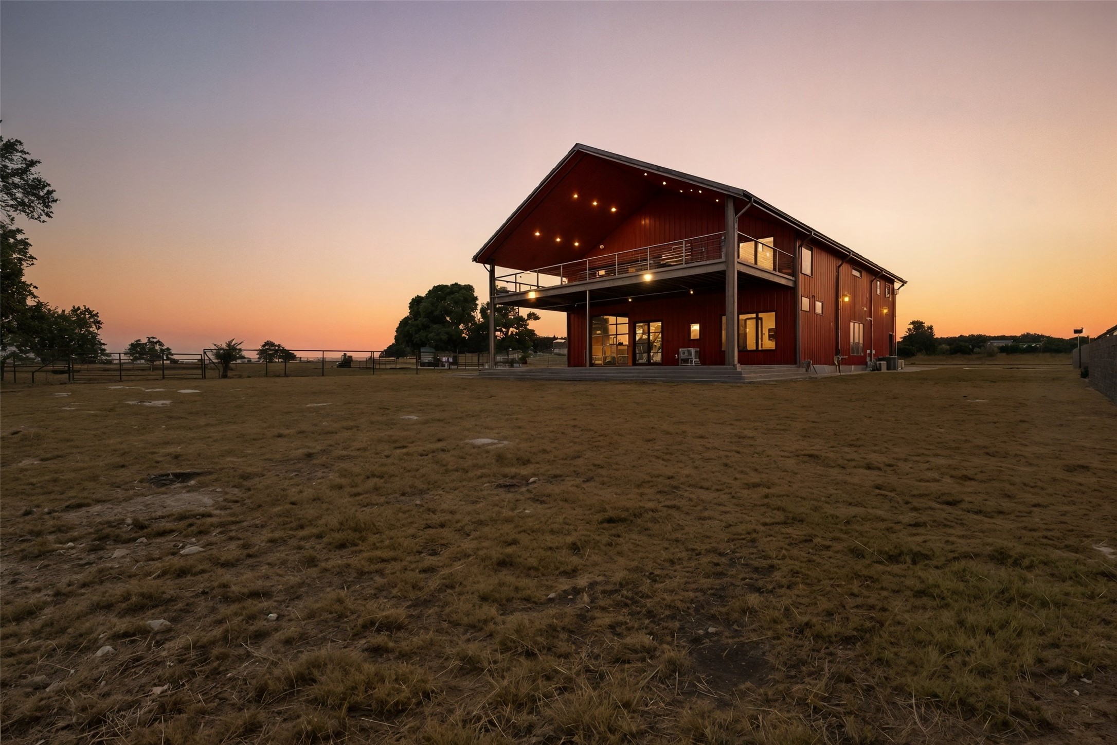 561 Broken Bit Trail Dripping Springs, TX 78620 - Photo 33 of 40 Back of property at dusk featuring a patio