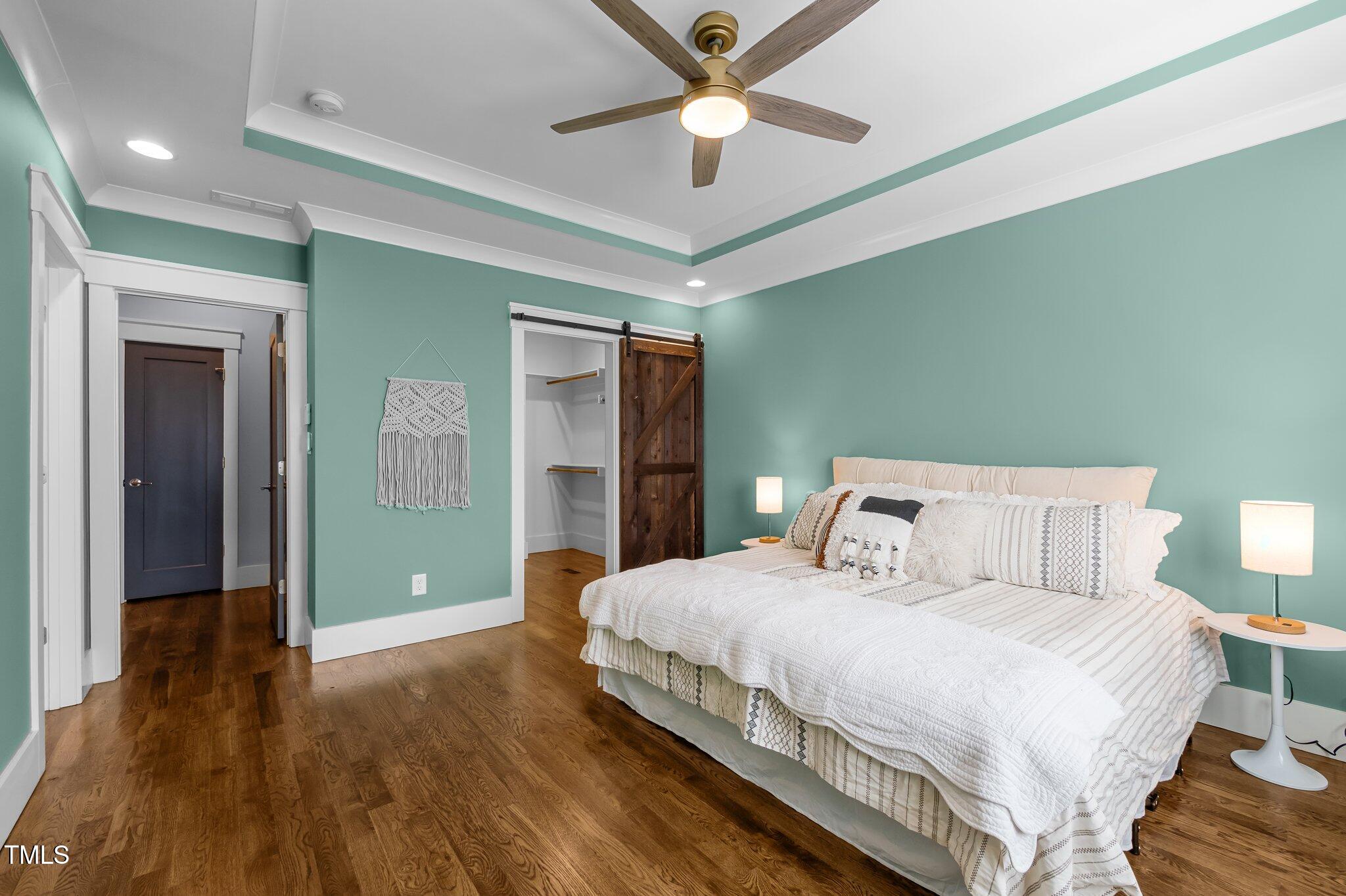 608 Dowd Street Durham, NC 27701 - Photo 10 of 24 a bedroom with a bed and a chandelier