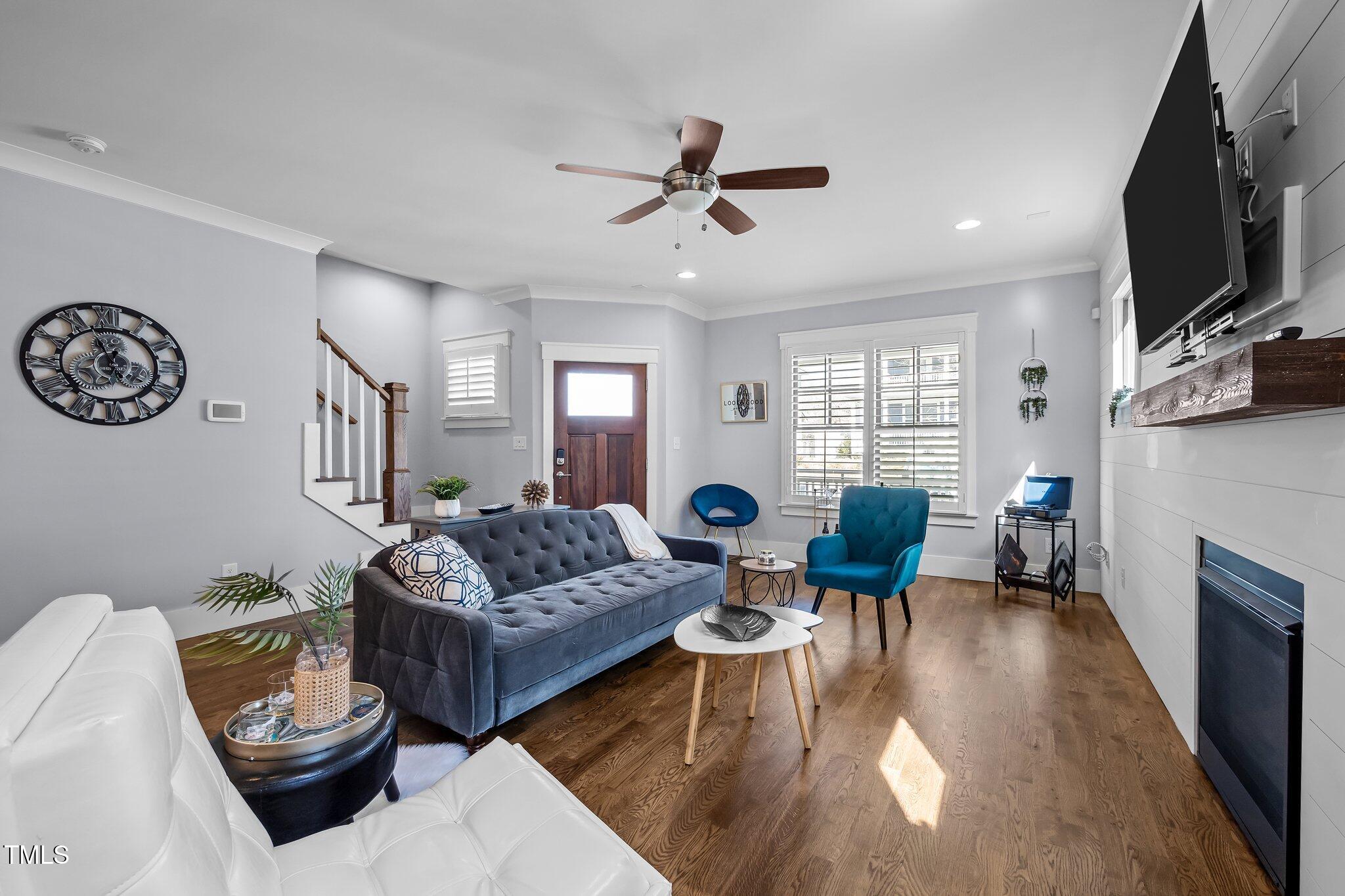 608 Dowd Street Durham, NC 27701 - Photo 3 of 24 a living room with furniture a fireplace and a flat screen tv