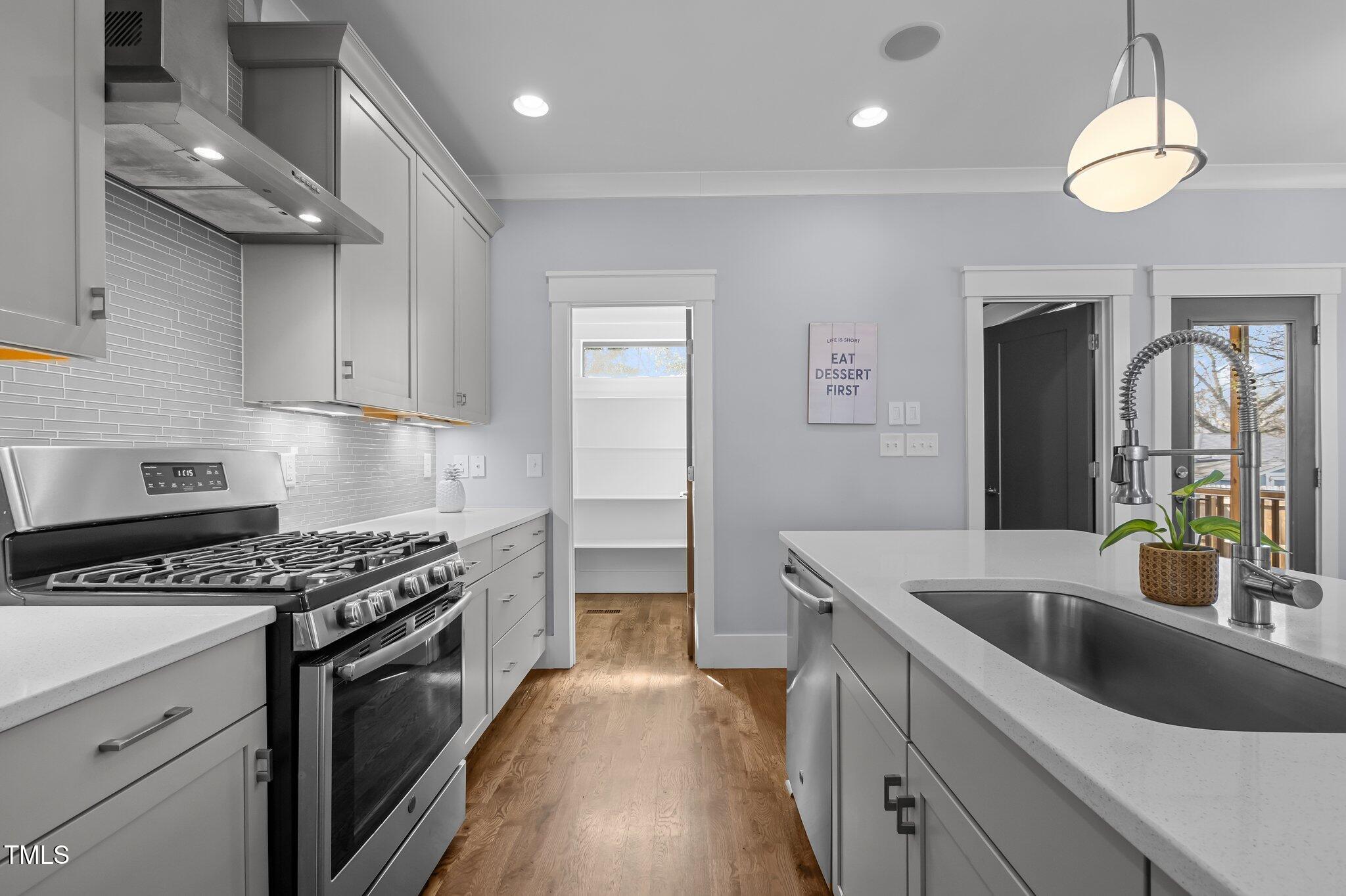 608 Dowd Street Durham, NC 27701 - Photo 7 of 24 a kitchen with stainless steel appliances granite countertop a sink stove and refrigerator