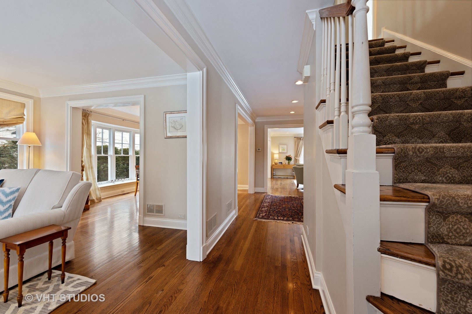 1075 Elm Street Winnetka, IL 60093 - Photo 16 of 40 a view of a hallway with wooden floor and staircase
