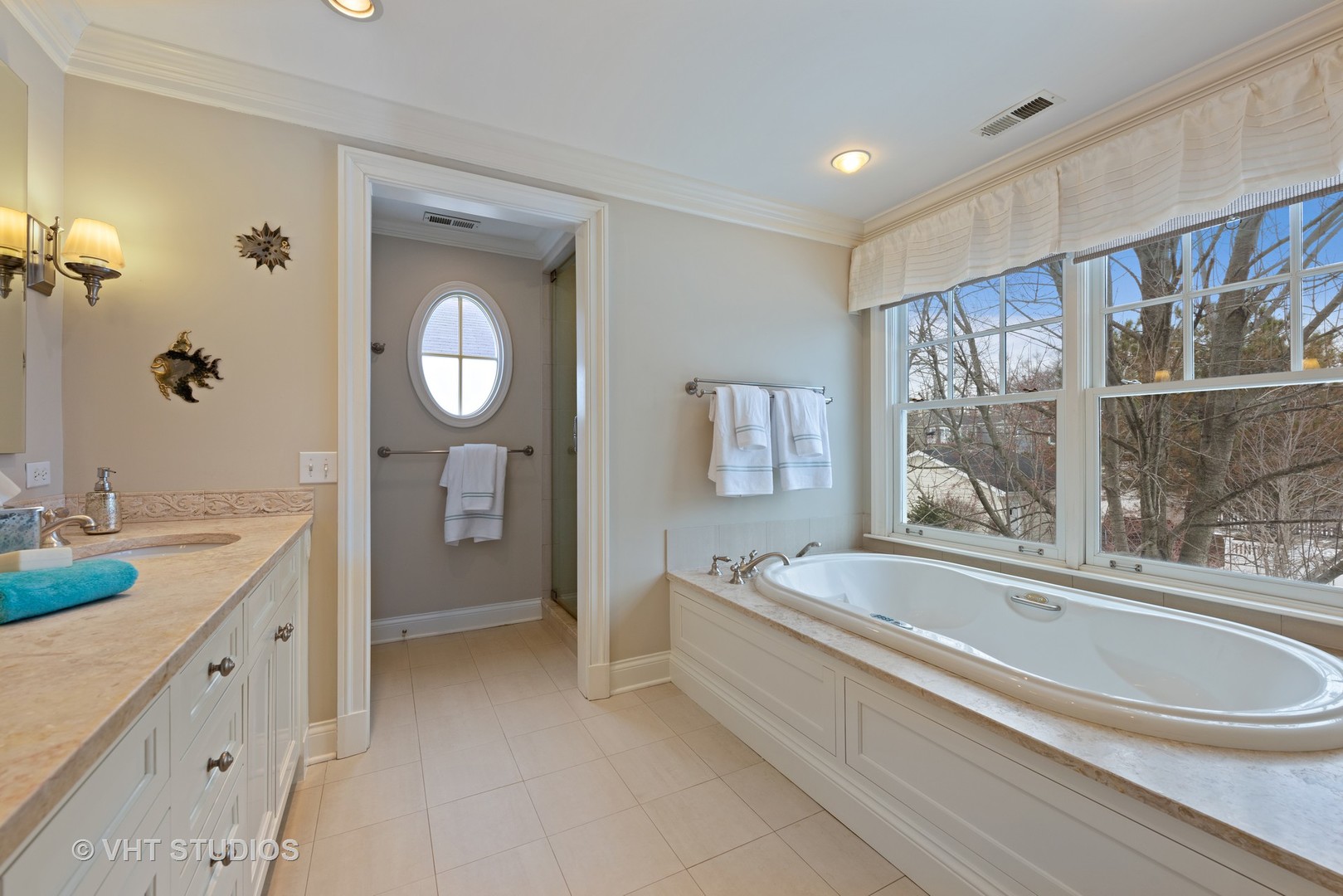 1075 Elm Street Winnetka, IL 60093 - Photo 21 of 40 a spacious bathroom with a bathtub a double vanity sink a mirror and a shower