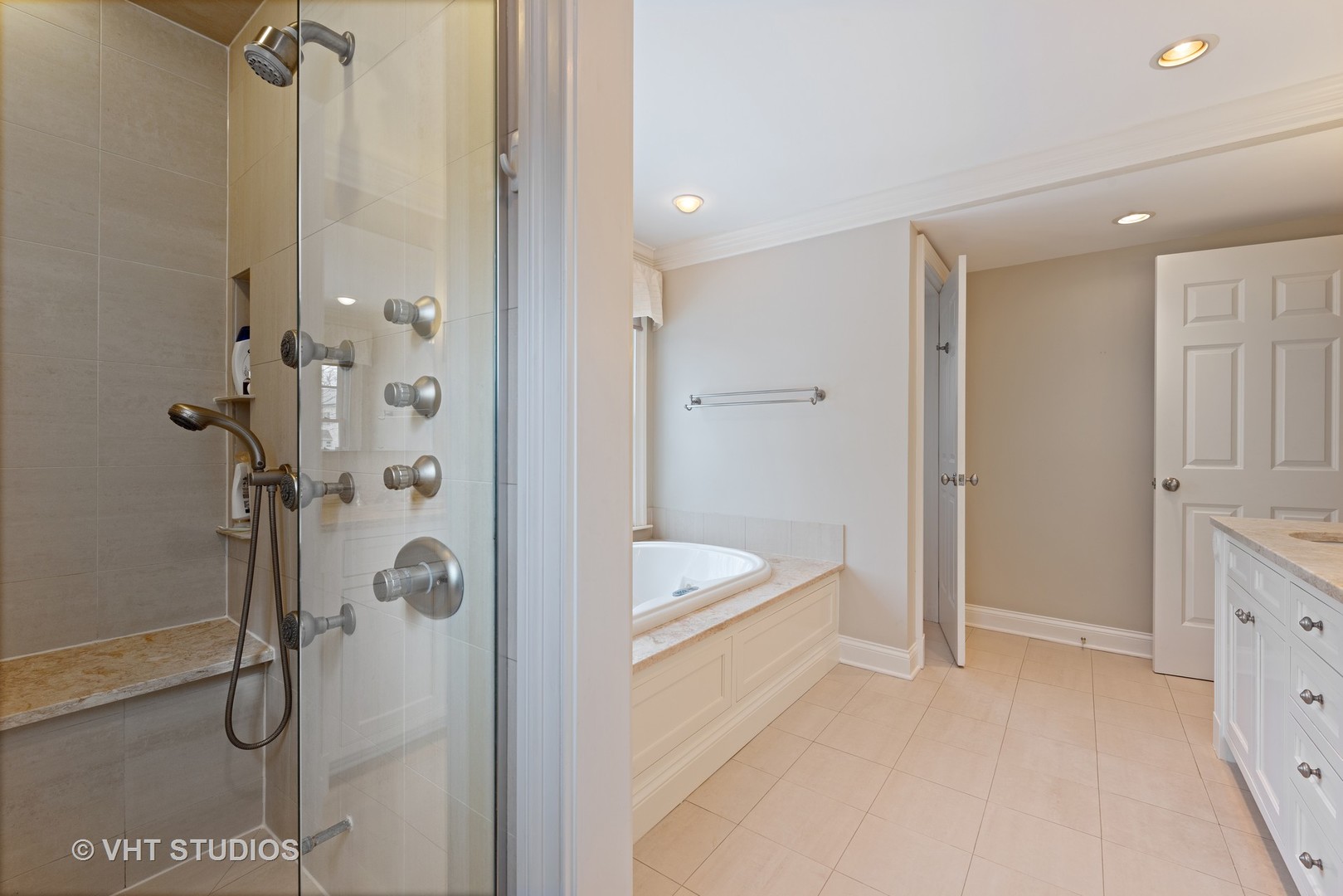 1075 Elm Street Winnetka, IL 60093 - Photo 22 of 40 a bathroom with a tub a sink and a shower