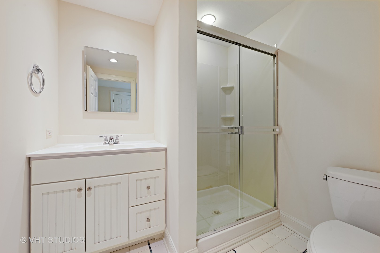 1075 Elm Street Winnetka, IL 60093 - Photo 29 of 40 a bathroom with a shower sink mirror and toilet