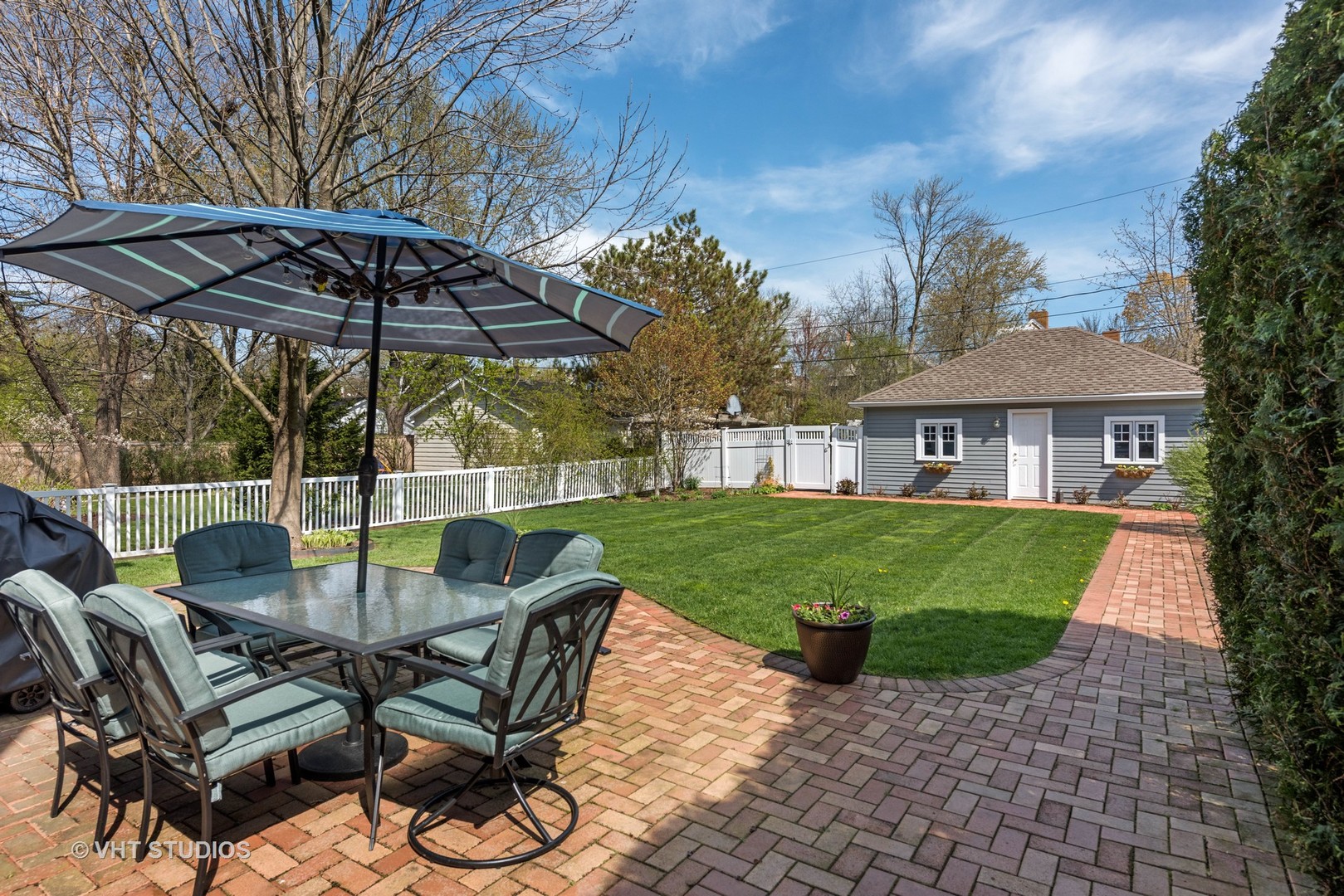 1075 Elm Street Winnetka, IL 60093 - Photo 33 of 40 a view of a patio with table and chairs under an umbrella