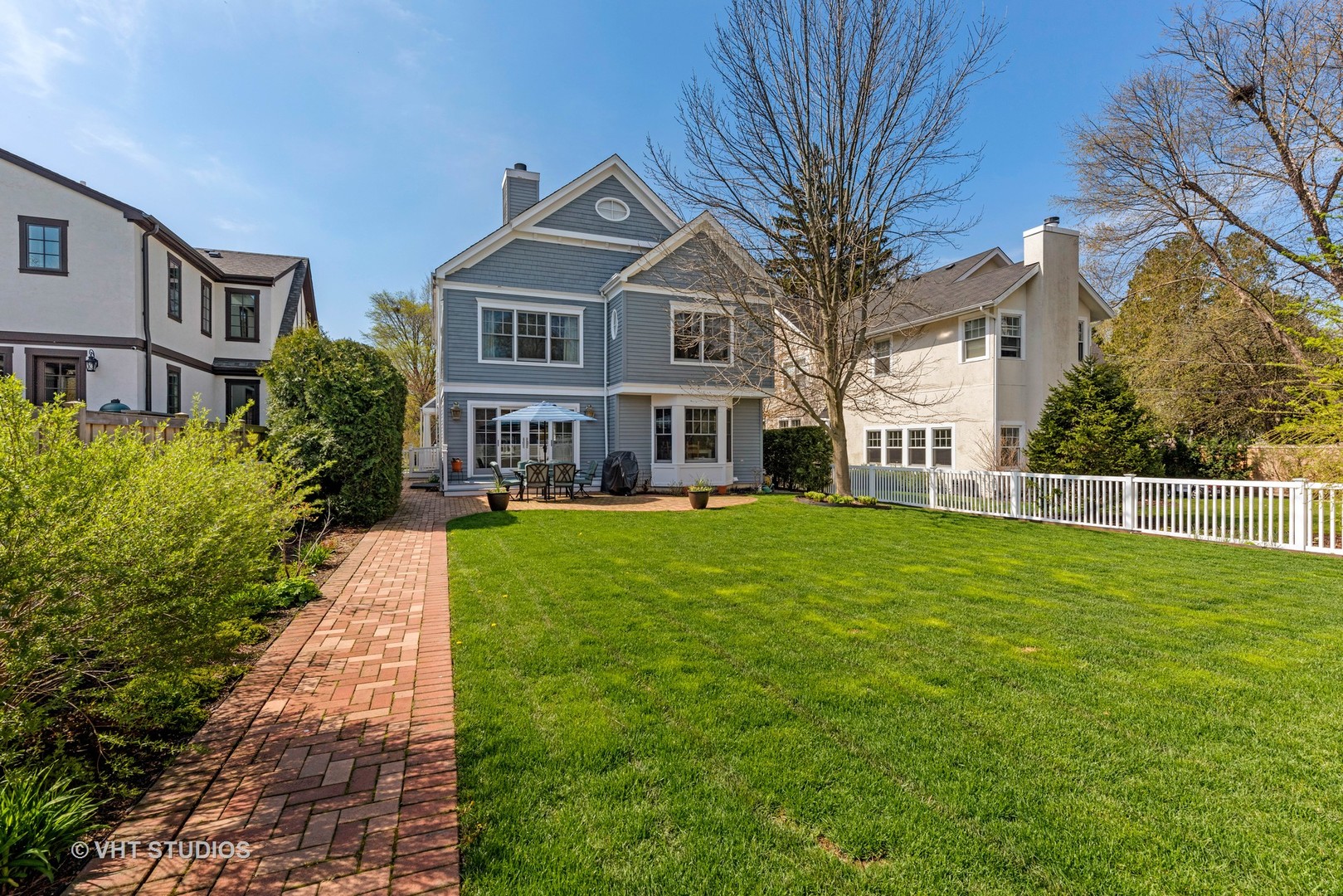 1075 Elm Street Winnetka, IL 60093 - Photo 34 of 40 a front view of a house with a garden