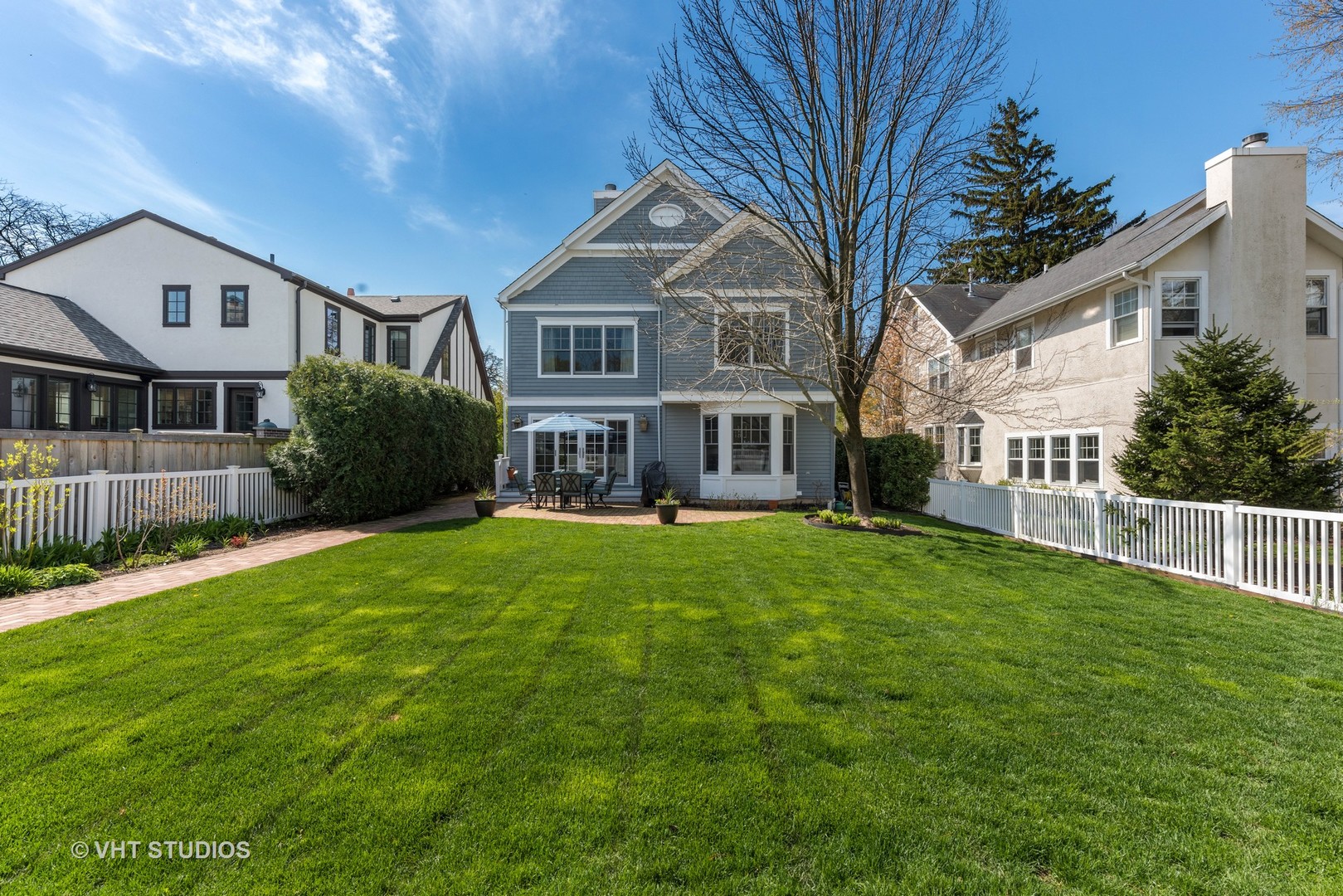 1075 Elm Street Winnetka, IL 60093 - Photo 35 of 40 a front view of a house with a garden and porch