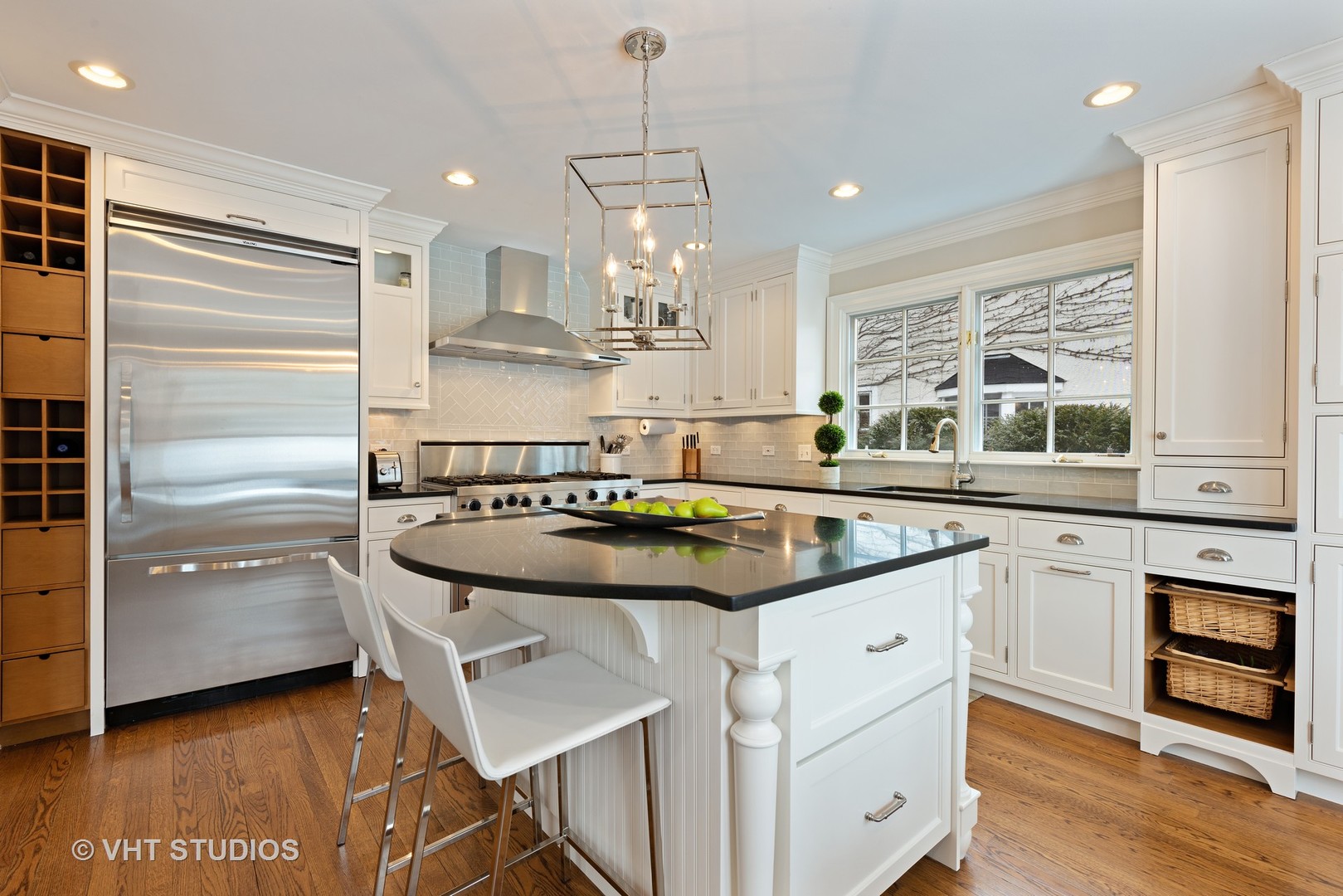 1075 Elm Street Winnetka, IL 60093 - Photo 7 of 40 a kitchen with kitchen island stainless steel appliances a sink stove and wooden floor