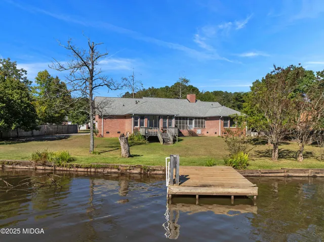 a house that has a tree in front of it