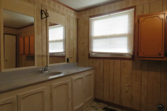 a bathroom with a shower a toilet and sink