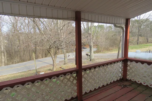 a view of a house with backyard and a tree