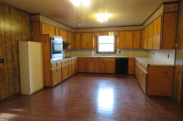 a kitchen with wooden cabinets and sink
