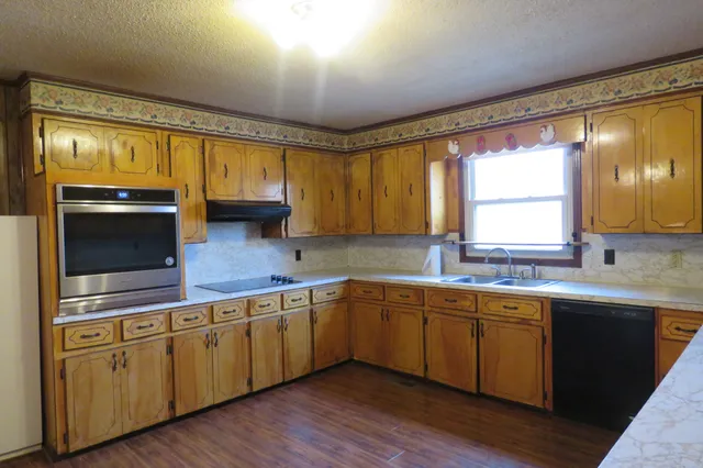 a view of a workspace with furniture and wooden floor