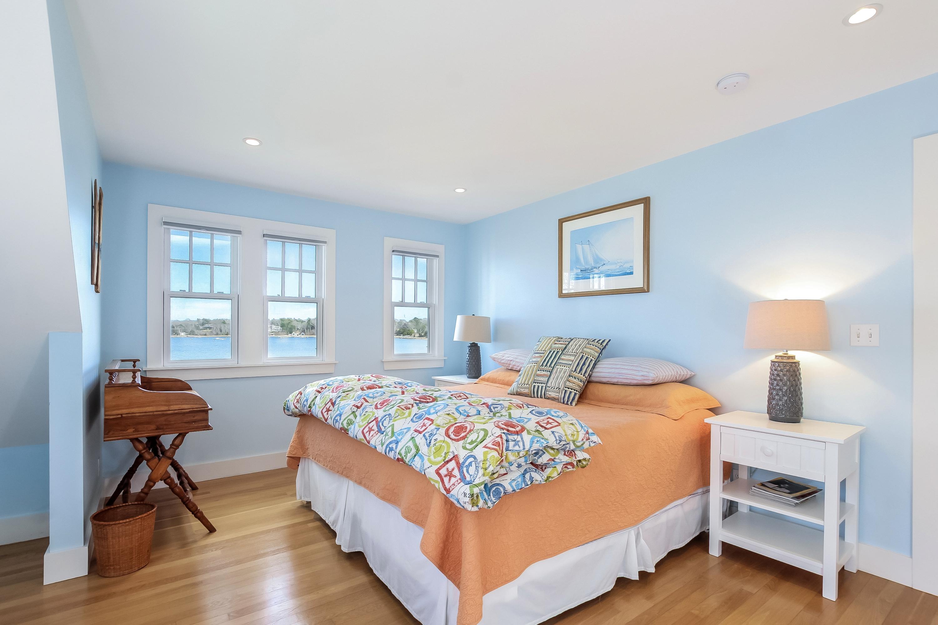 352 Scraggy Neck Road Cataumet, MA 02534 - Photo 12 of 36 a bedroom with a bed and a table in it