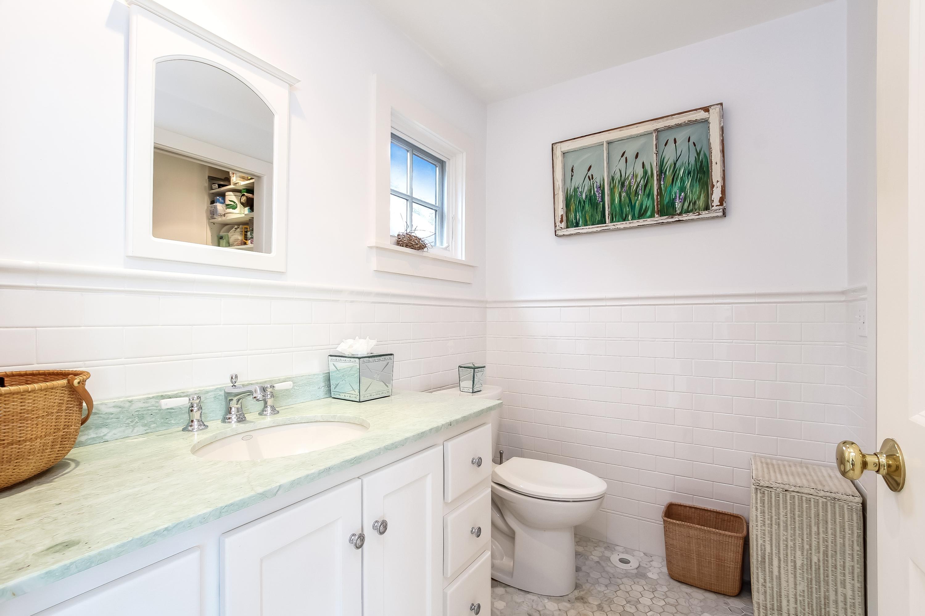 352 Scraggy Neck Road Cataumet, MA 02534 - Photo 14 of 36 a bathroom with a granite countertop toilet sink and mirror
