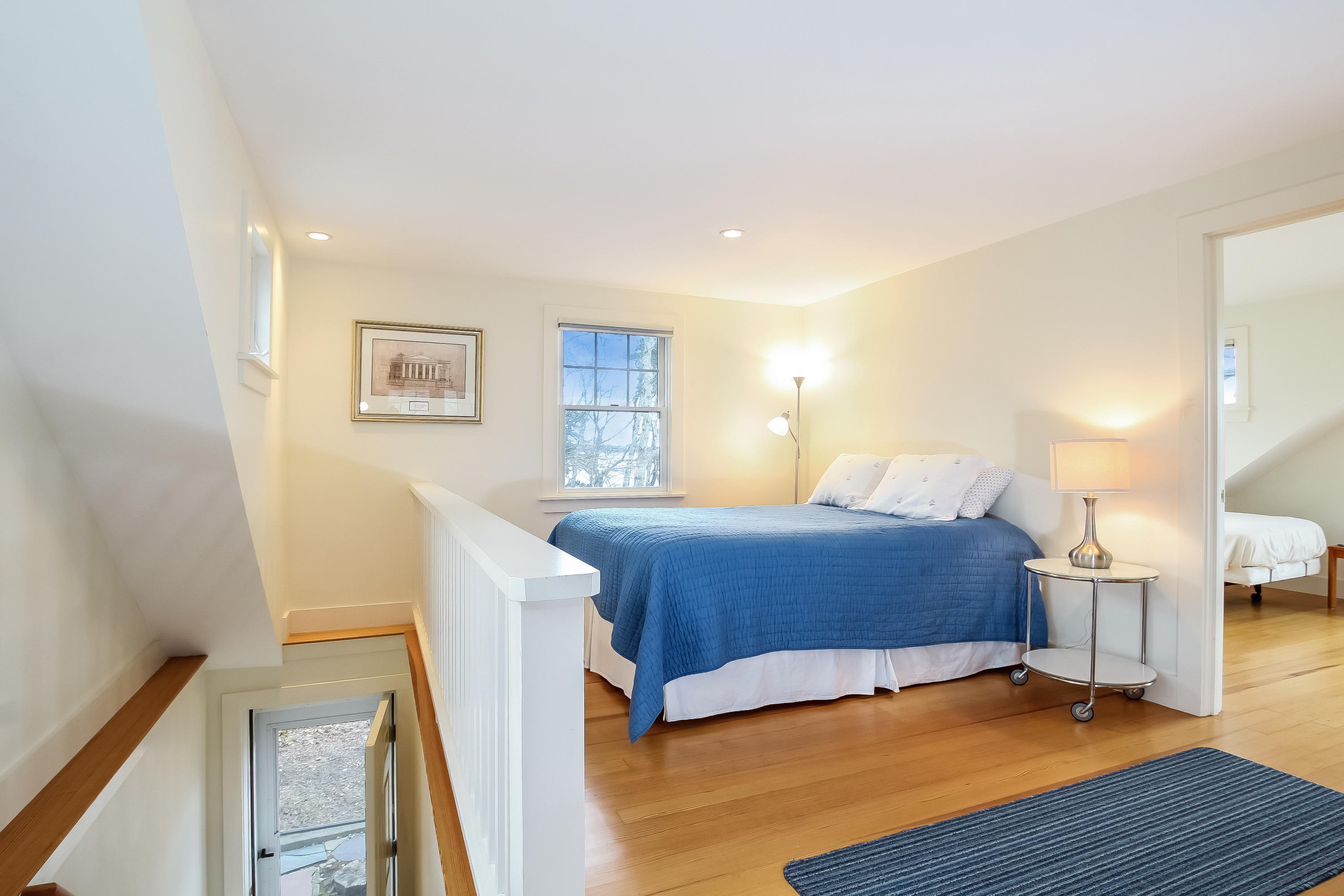 352 Scraggy Neck Road Cataumet, MA 02534 - Photo 16 of 36 a bedroom with a bed and wooden floor