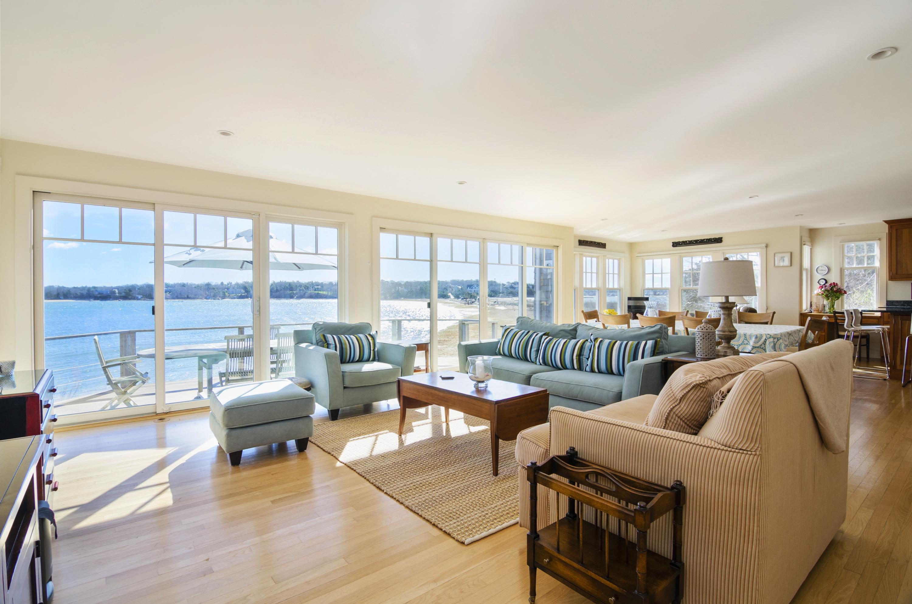 352 Scraggy Neck Road Cataumet, MA 02534 - Photo 2 of 36 a living room with furniture and a floor to ceiling window