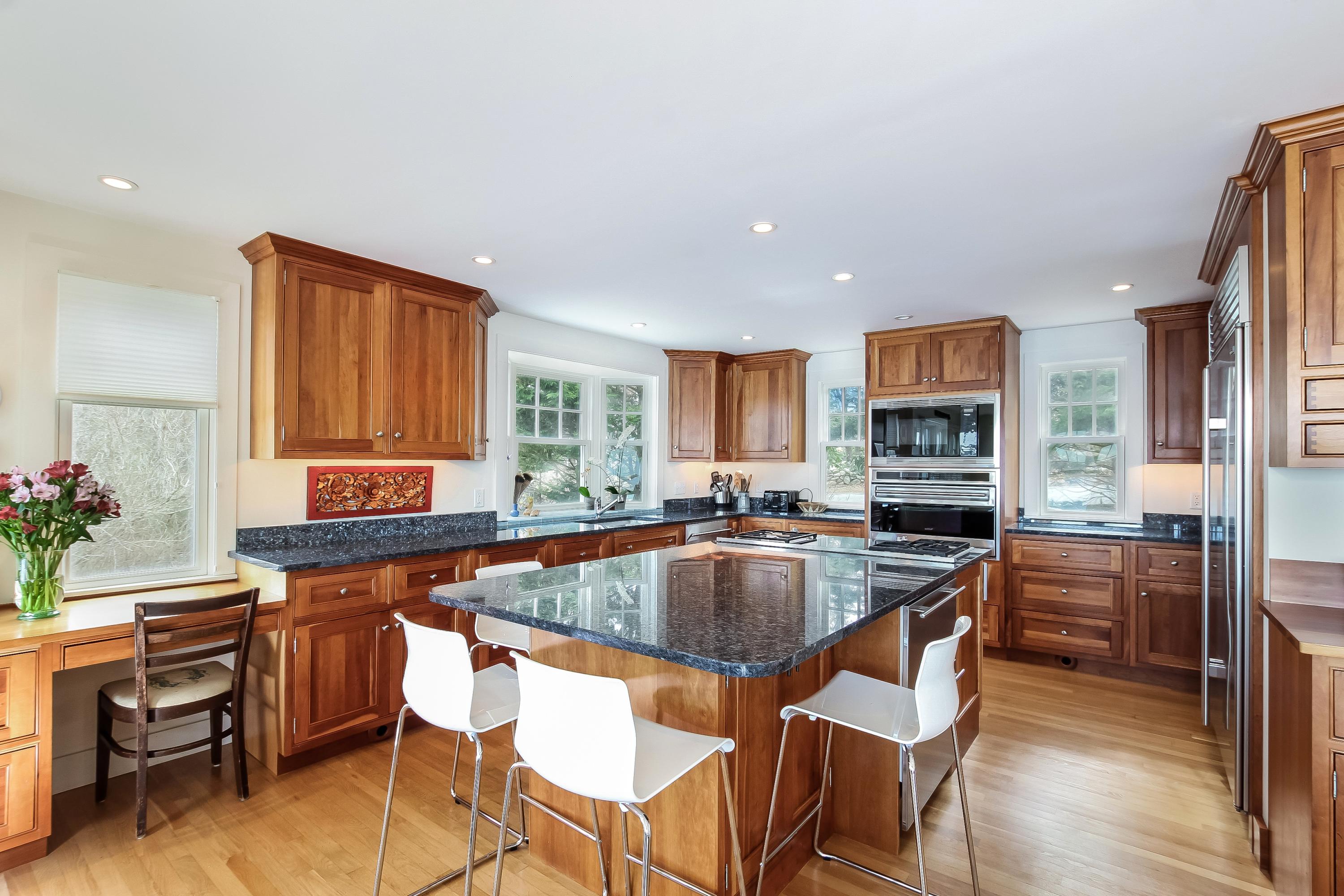 352 Scraggy Neck Road Cataumet, MA 02534 - Photo 5 of 36 a kitchen with a table chairs sink and cabinets