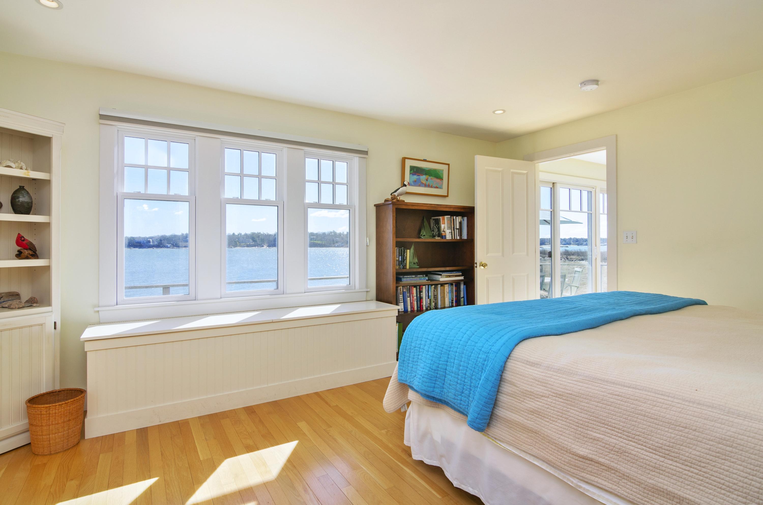 352 Scraggy Neck Road Cataumet, MA 02534 - Photo 7 of 36 a bedroom with a bed and a large window with outer view