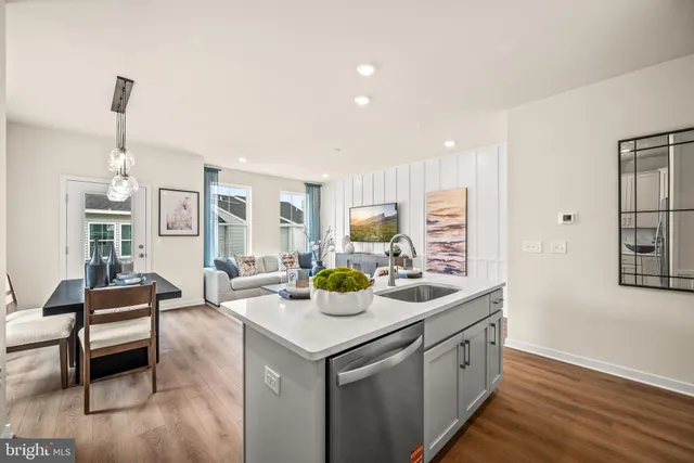 a kitchen with a sink and living room