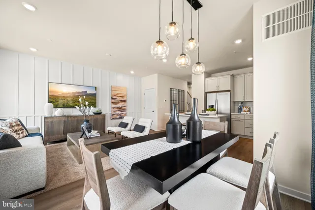 a living room with lots of furniture and a chandelier