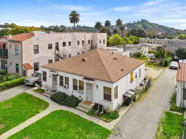 a aerial view of a house with a yard table and chairs