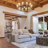 a living room with furniture a chandelier and a large window