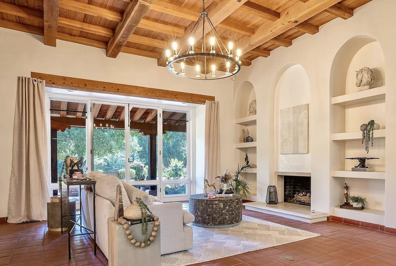 12 Vineyard Hill Road Woodside, CA 94062 - Photo 2 of 21 a living room with furniture a fireplace and a chandelier