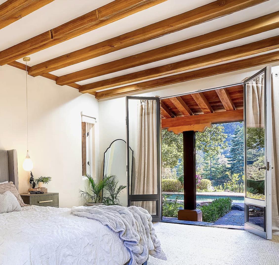 12 Vineyard Hill Road Woodside, CA 94062 - Photo 9 of 21 a bedroom with a bed and a large window with outer view