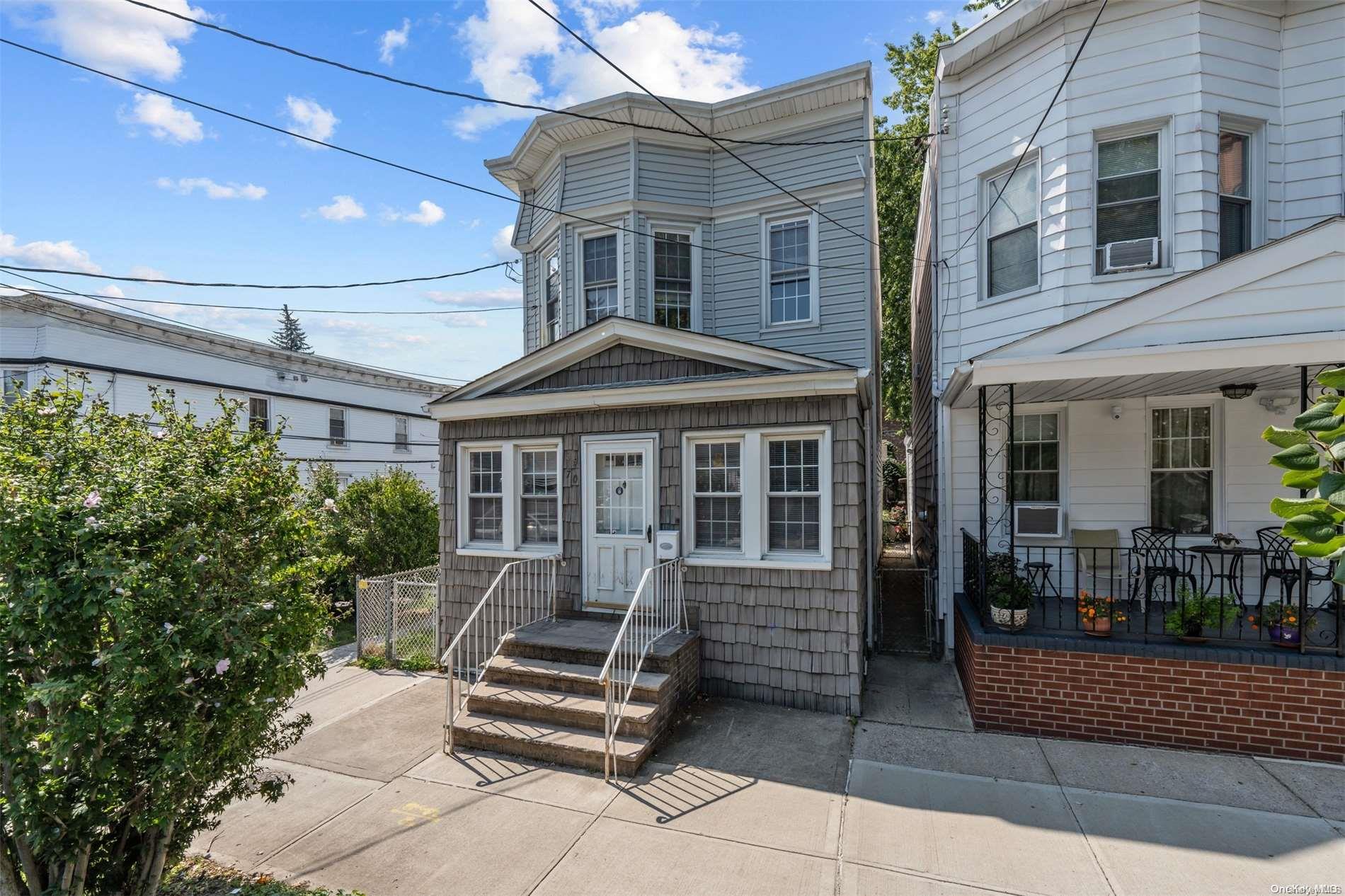 85-70 79th Street Queens, NY 11421 - Photo 1 of 18 a front view of a house with porch