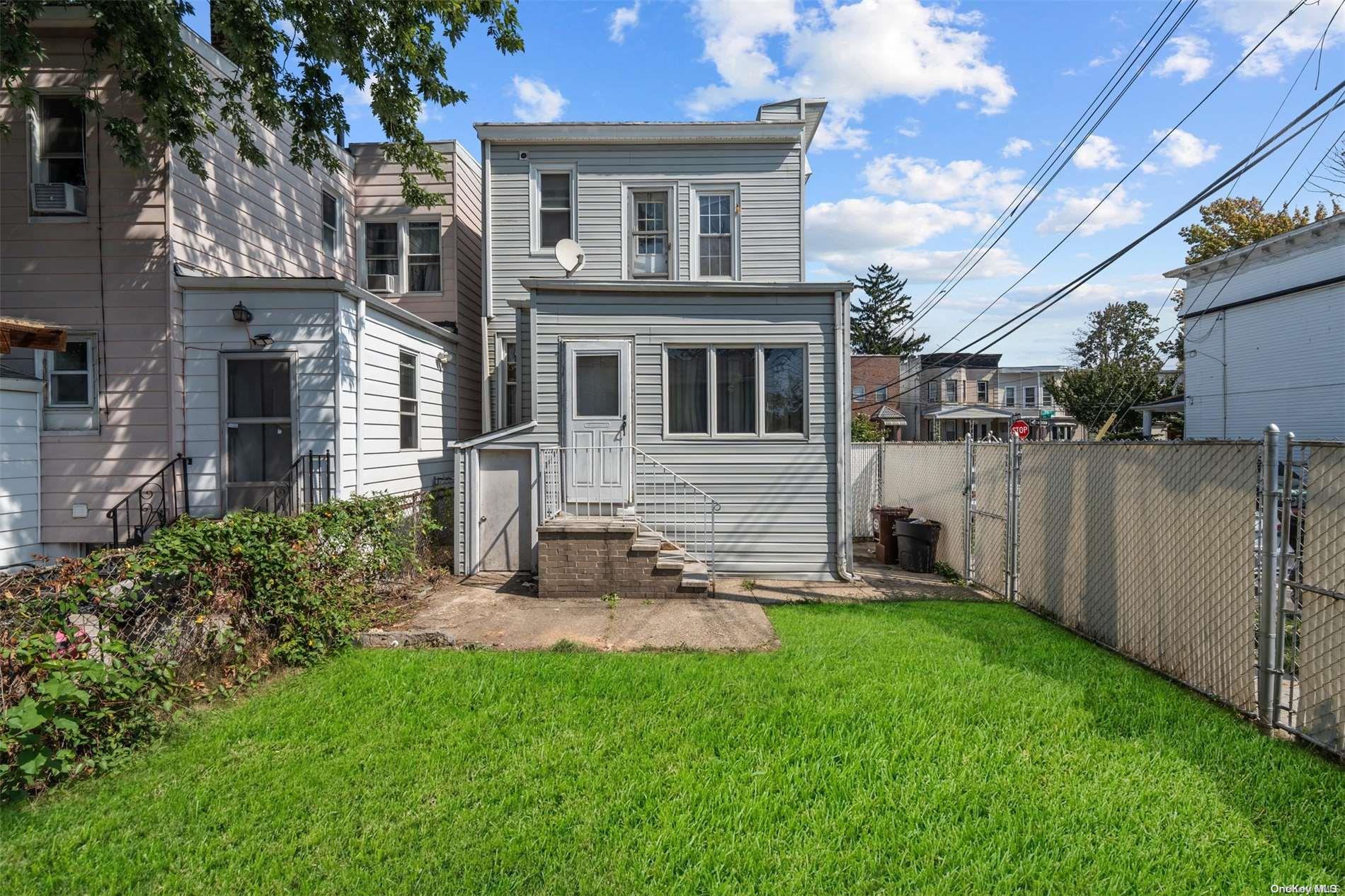 85-70 79th Street Queens, NY 11421 - Photo 17 of 18 a view of backyard of house with green space