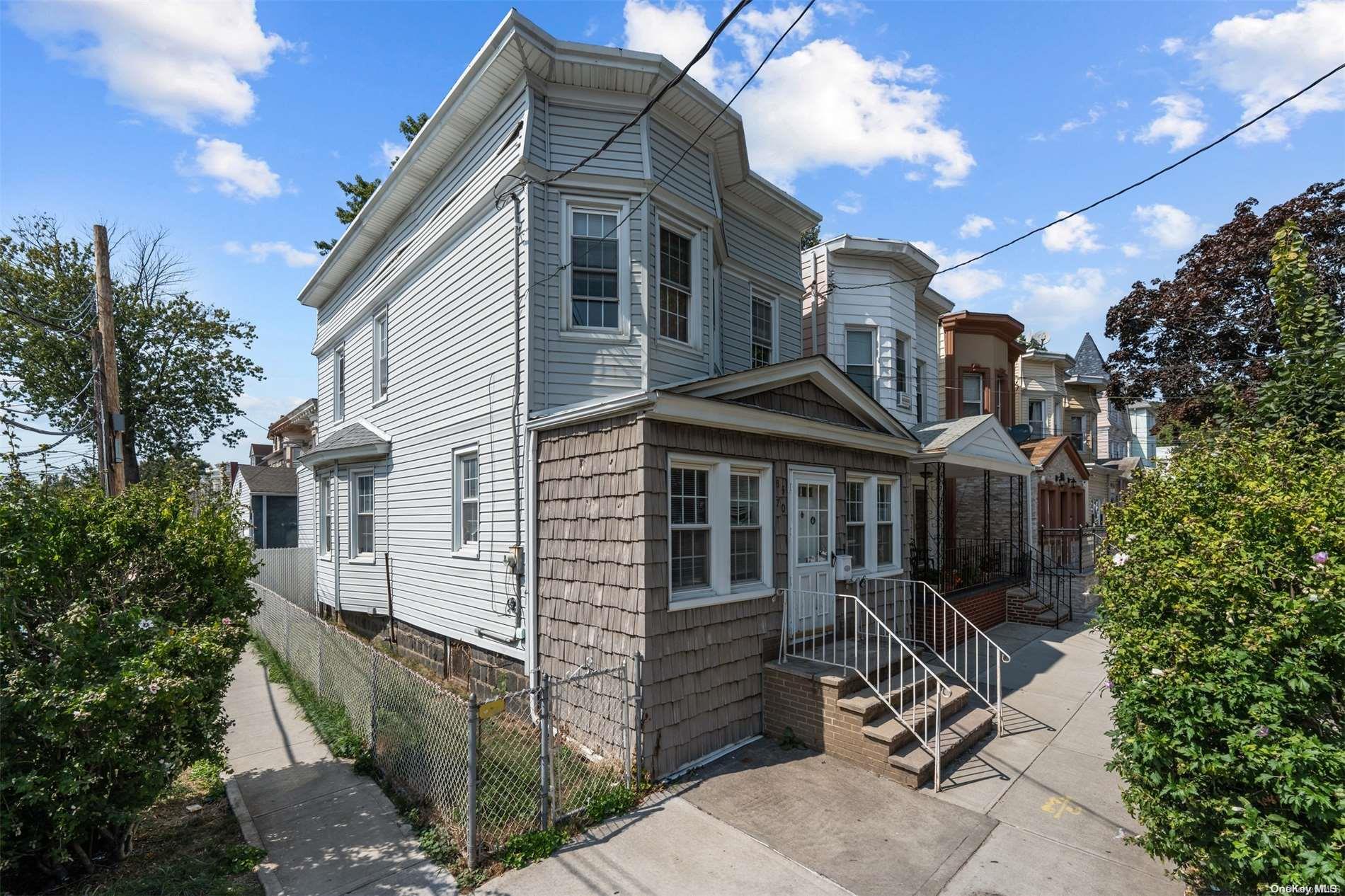 85-70 79th Street Queens, NY 11421 - Photo 18 of 18 a view of a house with a small yard and wooden fence