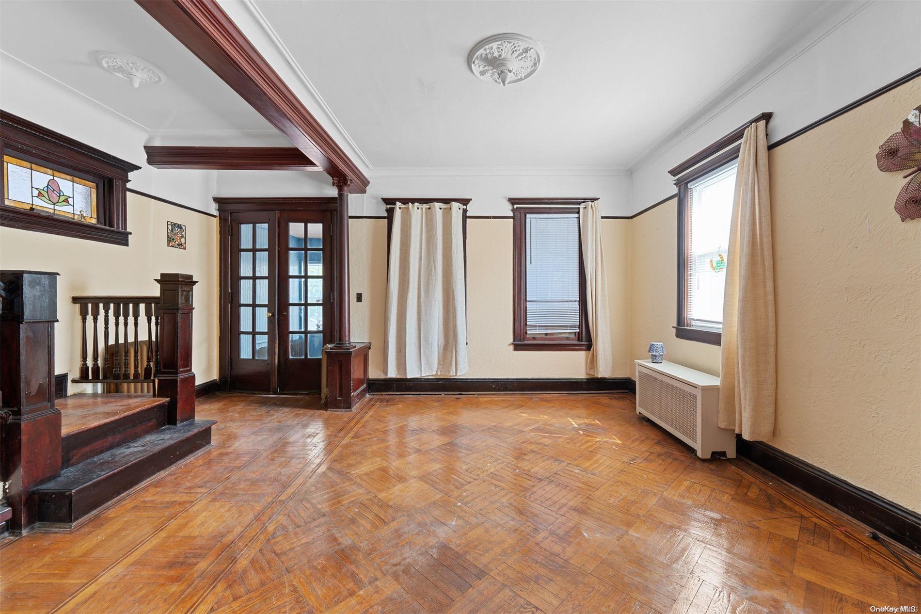 85-70 79th Street Queens, NY 11421 - Photo 4 of 18 a view of an empty room with a fireplace and a window