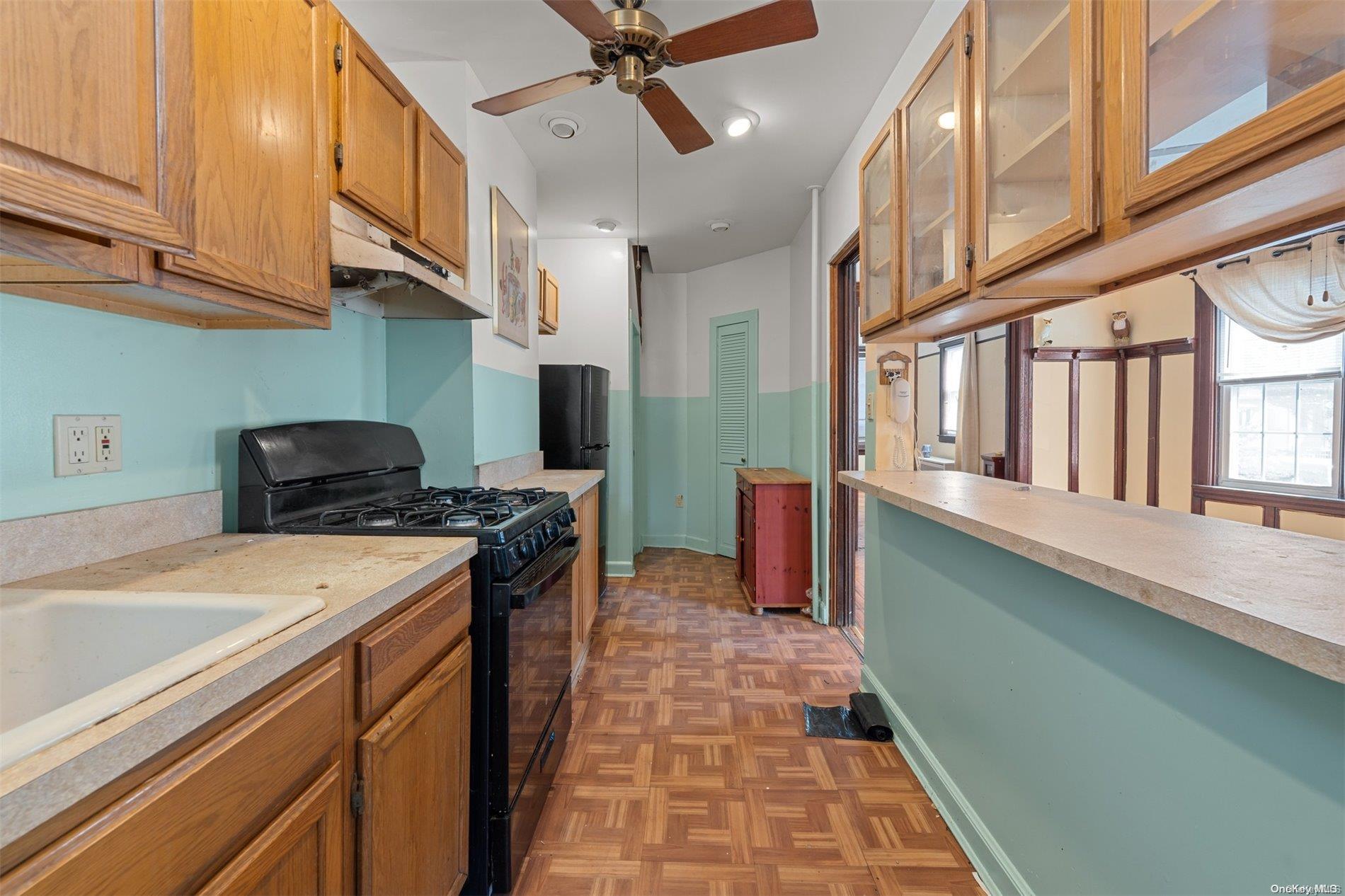 85-70 79th Street Queens, NY 11421 - Photo 7 of 18 a kitchen with stainless steel appliances granite countertop a stove and a sink
