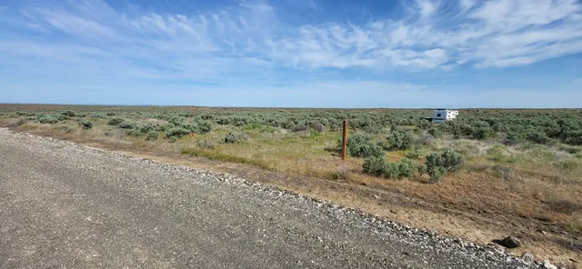 a view of a big yard with a city view
