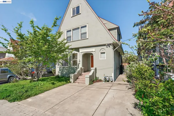 a view of a hallway with wooden floor and a bathroom