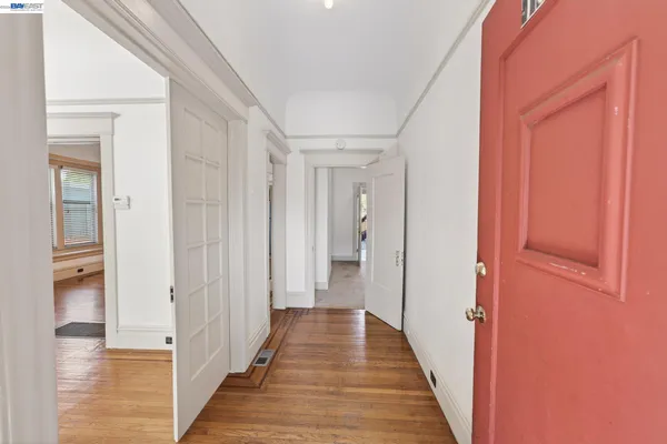 wooden floor in an empty room with a window