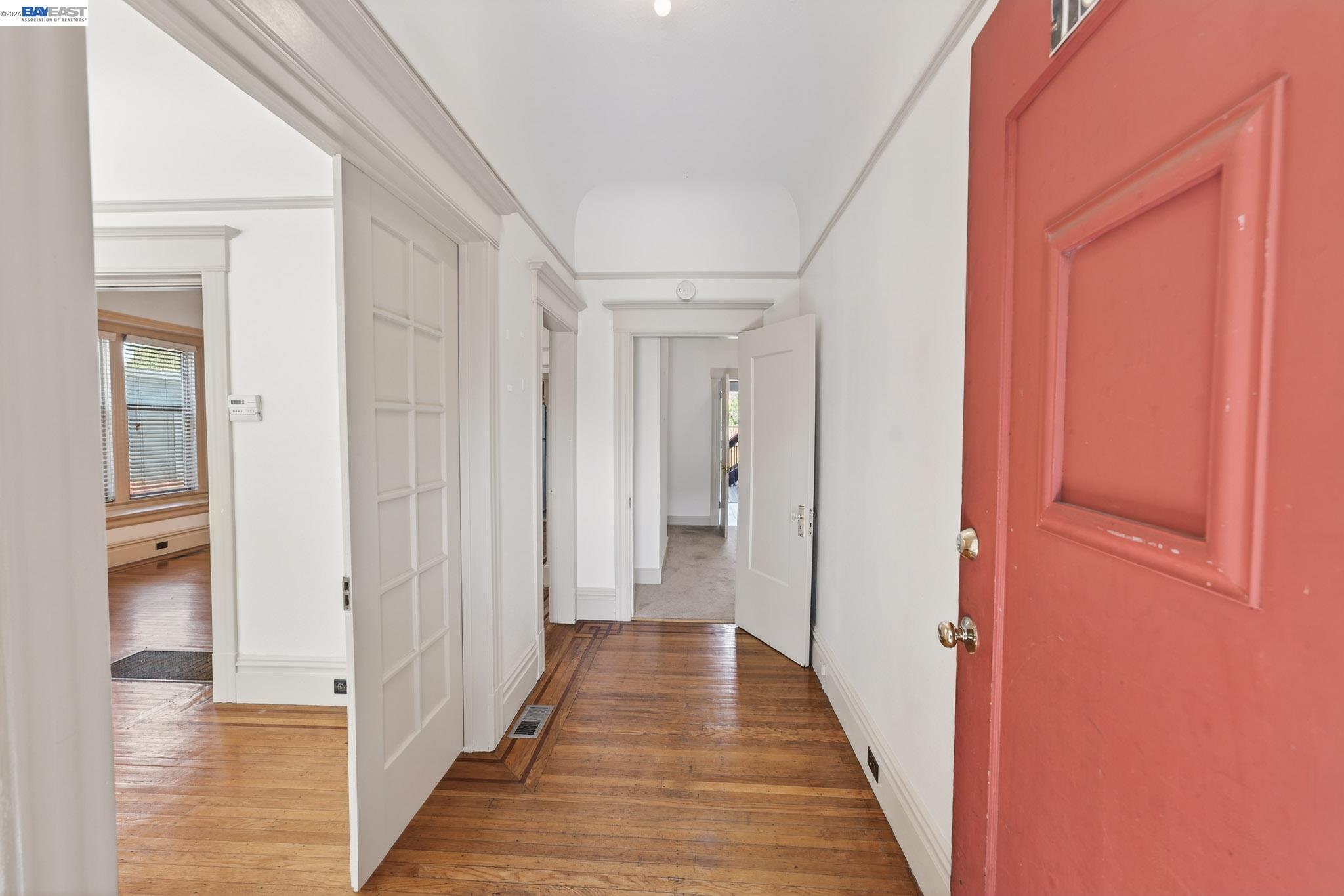 1835 Prince Street, Unit A Berkeley, CA 94703 - Photo 4 of 23 a view of a hallway with wooden floor and a bathroom