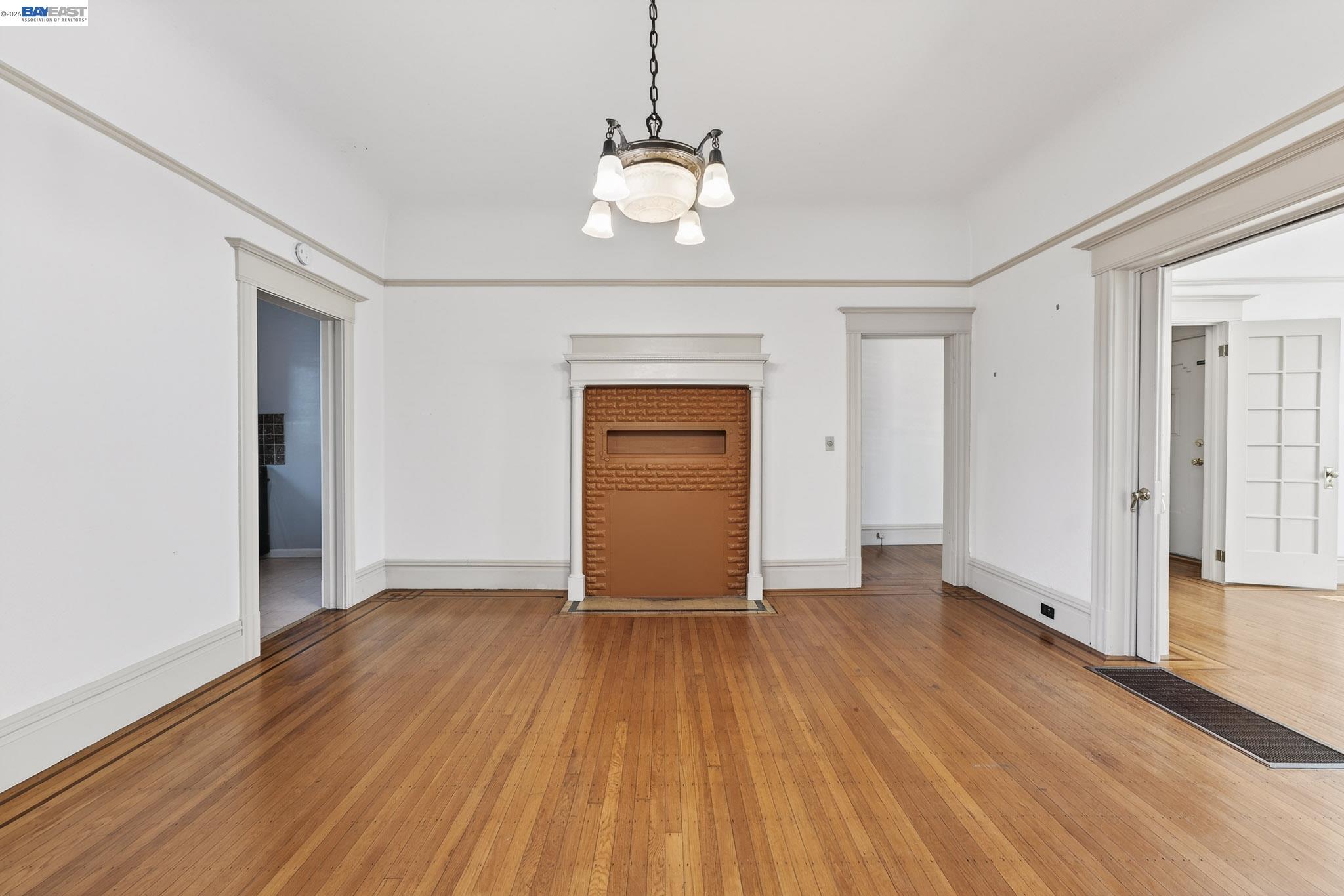 1835 Prince Street, Unit A Berkeley, CA 94703 - Photo 9 of 23 a view of an empty room with wooden floor and a window