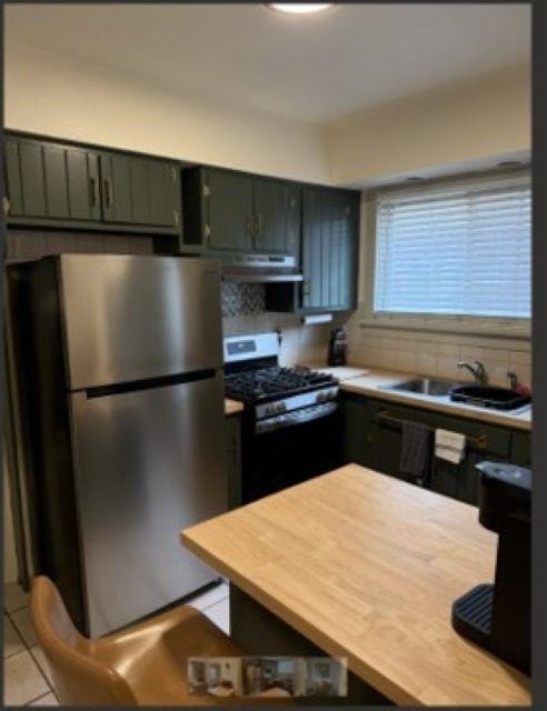 718 Seminary Street Rockford, IL 61104 - Photo 2 of 18 a kitchen with a refrigerator and a stove top oven