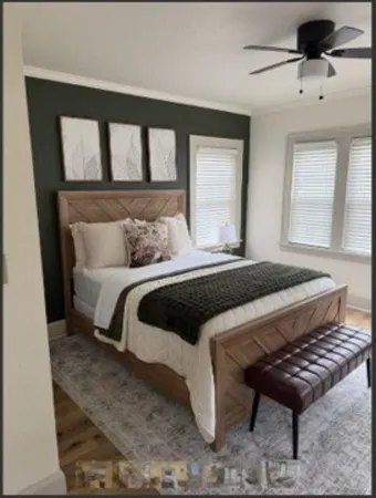 a bedroom with a bed and wooden floor