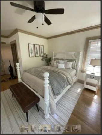a bedroom with a bed and a chandelier