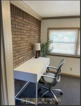 a view of a workspace with furniture