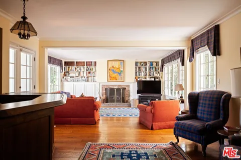 a living room with furniture window and wooden floor