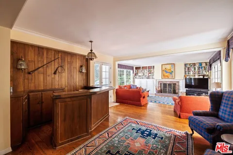 a living room with furniture a rug and a window