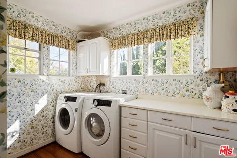 a bathroom with a sink and a washer dryer