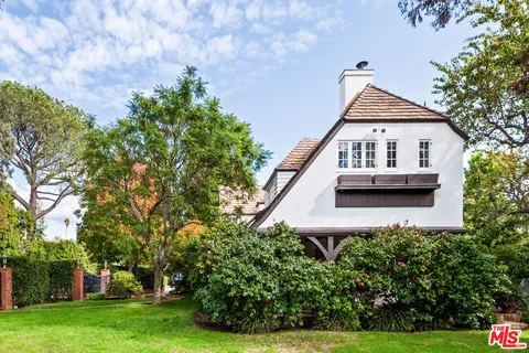 a house that has a tree in front of it
