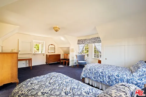 a bedroom with a bed and a couch