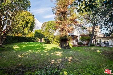 a view of a tree in front of a house